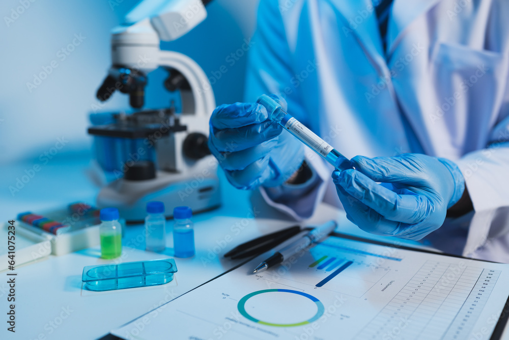Fototapeta premium medical research laboratory Asian male scientist working using digital tablet analyze the sample record biochemical data medical science laboratory development of microbiology advanced equipment.