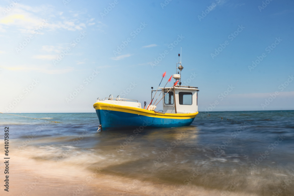 Fishing boat on the beach in Sopot, Poland. Magnificent long exposure calm Baltic Sea. Wallpaper defocused waves. Fishermans sea bay Vacation and holidays. travel attraction tourist destination 