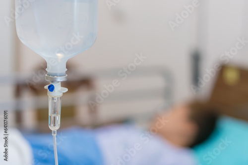 Normal saline solution or sodium chloride with infusion bottle drip for patient in hospital, Intravenous system of operating surgeons