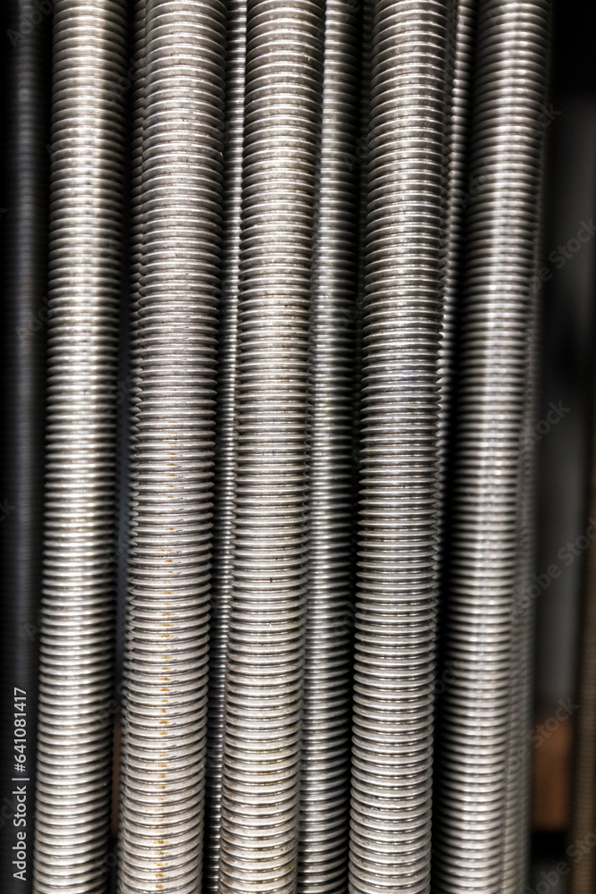Macro photo of threaded rod in a row Macro photo of threaded rod in a row