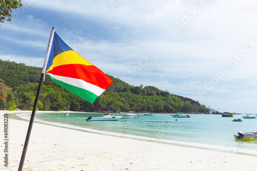 The flag of Seychelles mounted on the beach