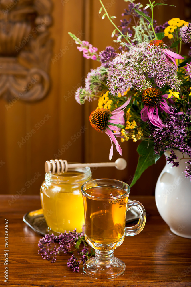 Still life from medicinal herbs, honey, herbal tea on a wooden background Still life from medicinal herbs, honey, herbal tea on a wooden background