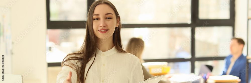 © megaflopp - A beautiful woman in office holds out a hand for greeting © megaflopp - A beautiful woman in office holds out a hand for greeting
