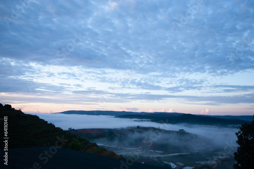 Dawn on the outskirts of Da Lat, a morning with dew covering the hilltops, in the sky there are beautiful colorful fish scale clouds. © trong