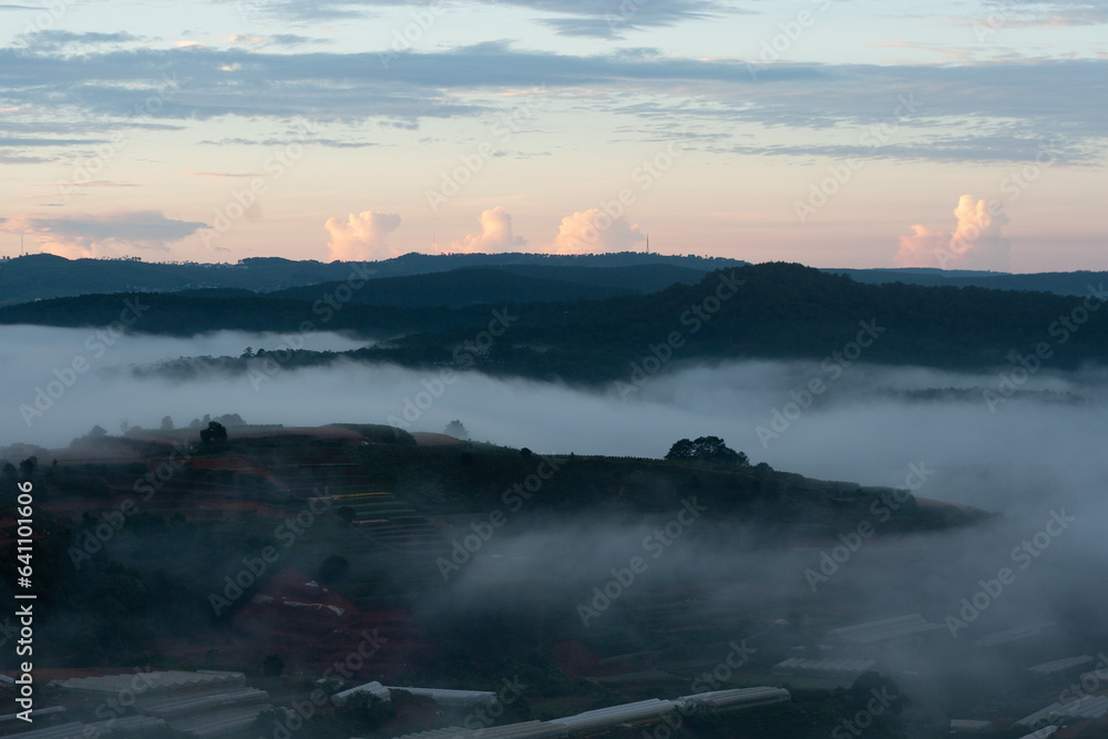 Dawn on the outskirts of Da Lat, a morning with dew covering the hilltops, in the sky there are beautiful colorful fish scale clouds.