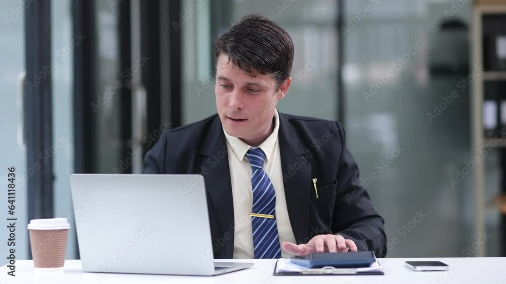 Businessman working with laptop computer at office workplace. Businessman working with laptop computer at office workplace.