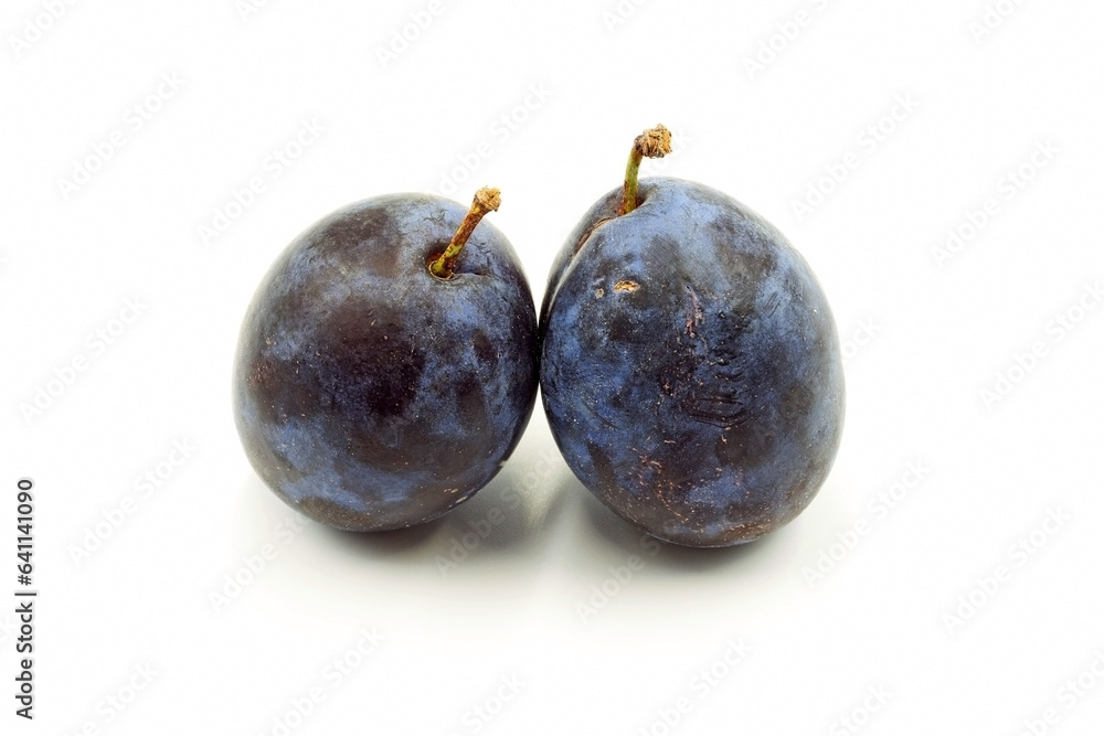 Two violet plums on a white background