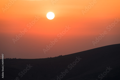 The sun sets on the mountain. Beautiful sunset in a mountainous area. © bogdan vacarciuc