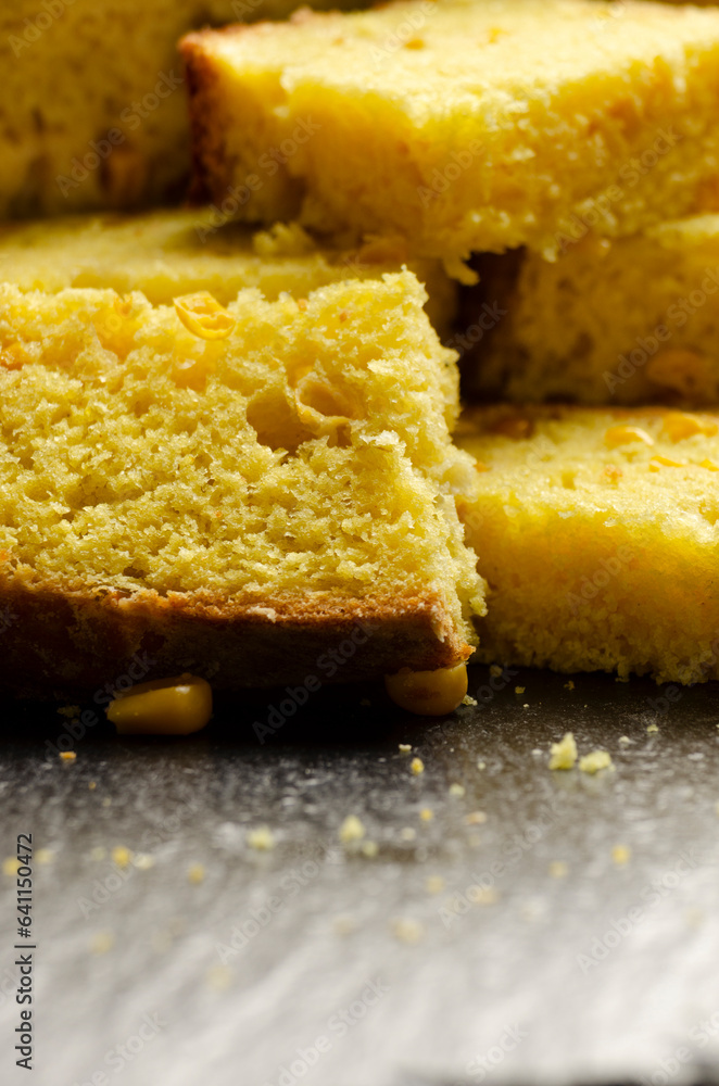 Homemade cornbread slices on kitchen table zoomed image