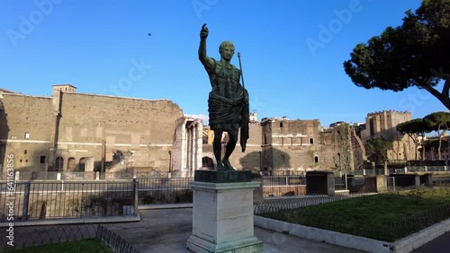 Pov view of Trajan imperator statue located Fori Imperiali street in Rome