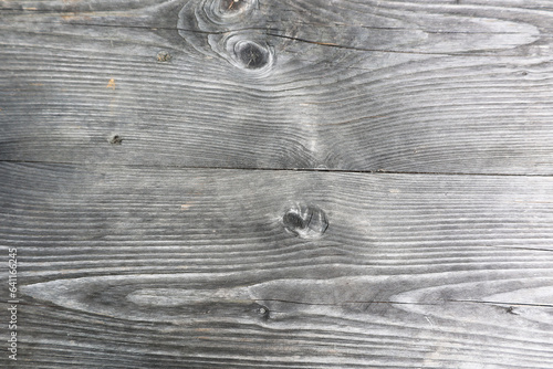 grey weathered wood detail plane straight board with knotholes photo