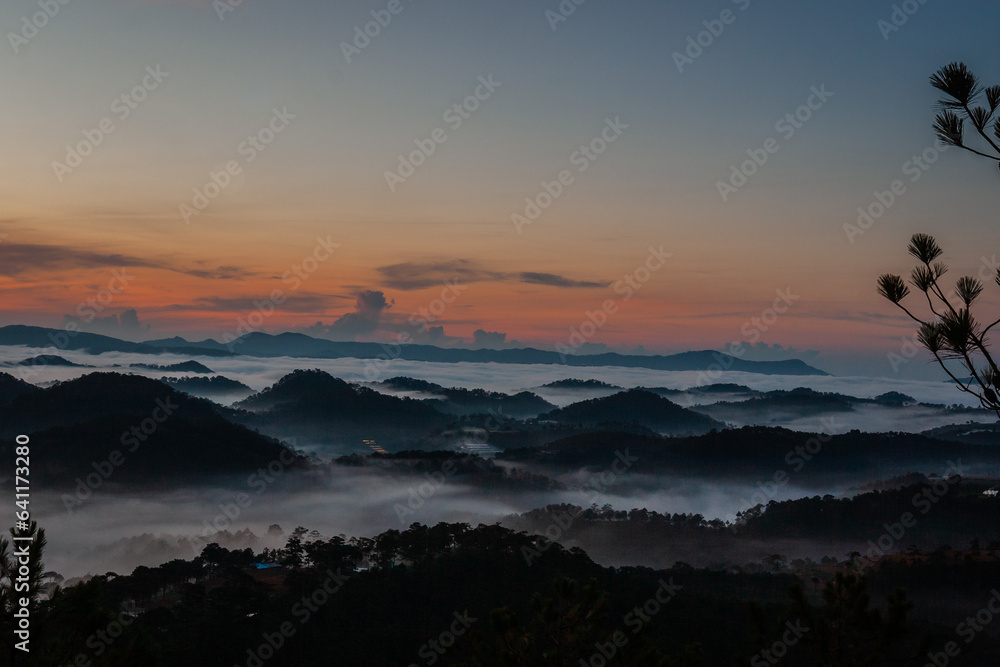 The scenery of Da Lat mountains and forests engulfed in morning mist The scenery of Da Lat mountains and forests engulfed in morning mist