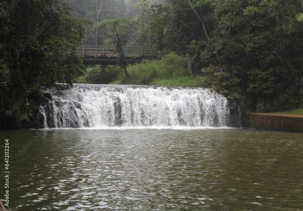Malanda Falls waterfall on a misty and rainy day in Far North Queensland, Australia Malanda Falls waterfall on a misty and rainy day in Far North Queensland, Australia