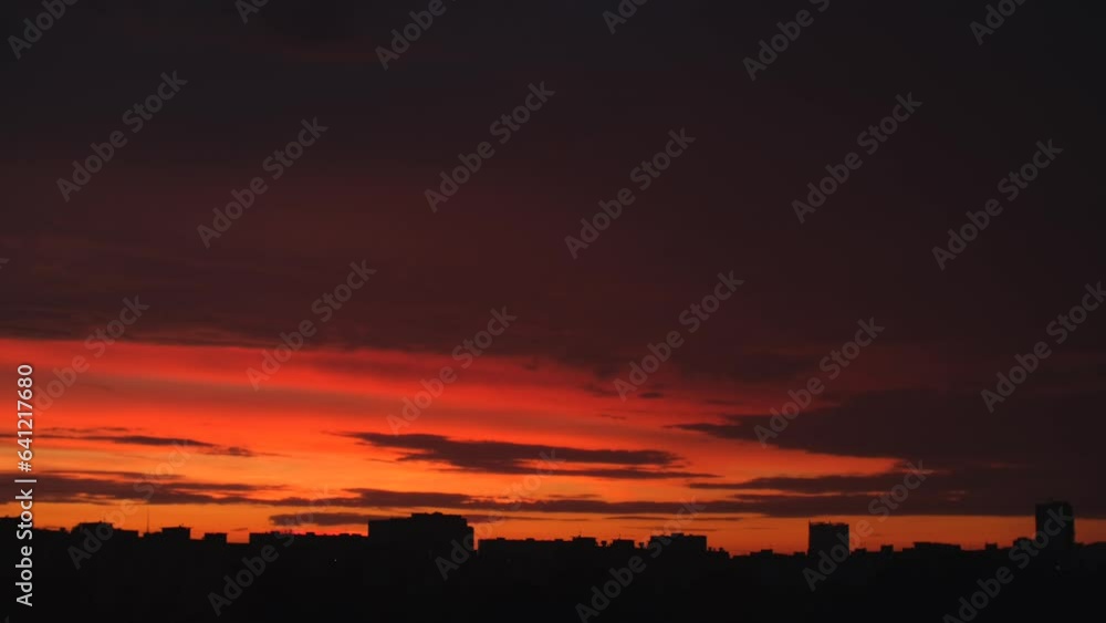 Sunset over city static timelapse. Dramatic cloudy sky, beautiful nature cloudscape scene with contrast blue and orange glow Sunset over city static timelapse. Dramatic cloudy sky, beautiful nature cloudscape scene with contrast blue and orange glow