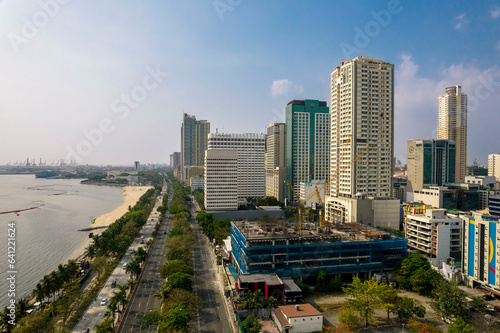 Manila, Philippines - Afternoon aerial of Manila skyline showing the dolomite beach in Manila bay and promenade along Roxas Boulevard.