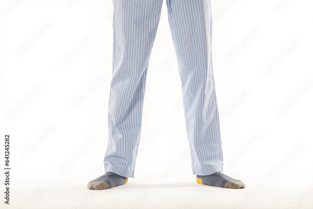 Man wearing a casual pajama. Legs detail. White background Man wearing a casual pajama. Legs detail. White background