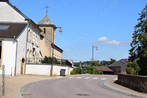 Fototapeta Naklejka Na Ścianę i Meble -  idyllic French village street with the church