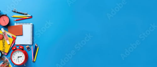 Back to school concept. Colorful stationary on blue background. Backpack with school supplies. Top view. Copy space. Banner