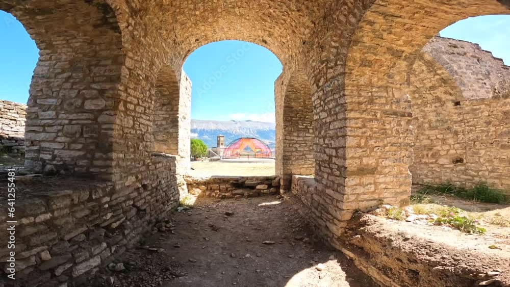 Interiors of the Ottoman castle fortress of Gjirokaster or Gjirokastra and the clock tower in the background. Albanian Interiors of the Ottoman castle fortress of Gjirokaster or Gjirokastra and the clock tower in the background. Albanian