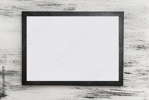 black frame for text with white letter on light wooden background
