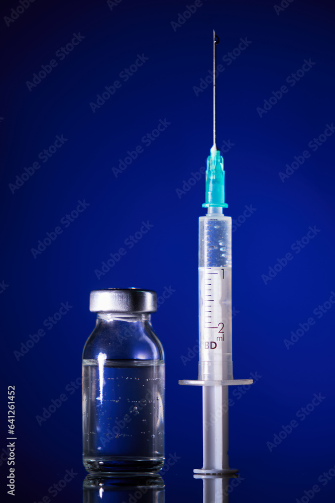 Syringe and glass ampoule in dark room Syringe and glass ampoule in dark room