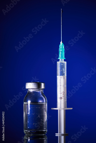 Syringe and glass ampoule in dark room