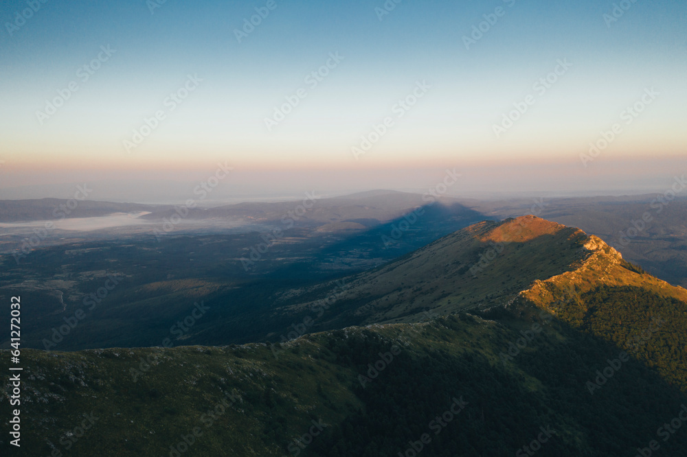 Obraz premium Pyramid shape shade of Rtanj mountain peak on sunrise 
