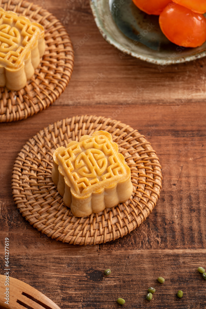 Delicious Cantonese moon cake for Mid-Autumn Festival food mooncake on wooden table background. Delicious Cantonese moon cake for Mid-Autumn Festival food mooncake on wooden table background.