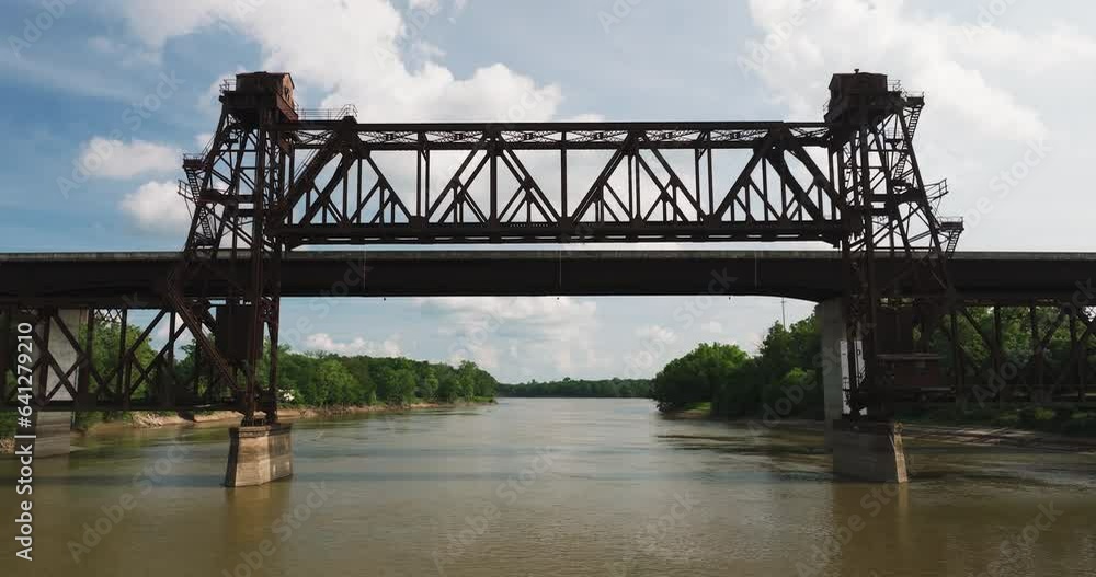 Flying Through Rusty Truss Bridge Over White River In Twin City Riverfront Park, Arkansas, USA. Aerial Drone Shot Flying Through Rusty Truss Bridge Over White River In Twin City Riverfront Park, Arkansas, USA. Aerial Drone Shot