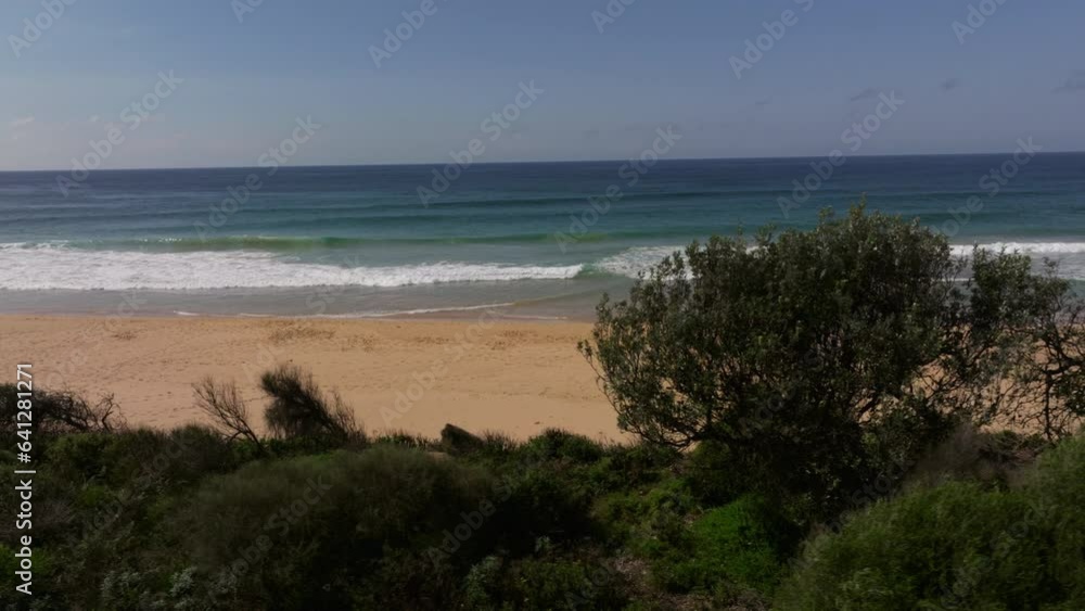 Drone revealing shot of empty Gillards beach in Australia on a sunny day. Drone revealing shot of empty Gillards beach in Australia on a sunny day.