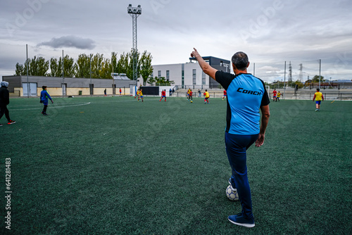Soccer coach, directing a training session.