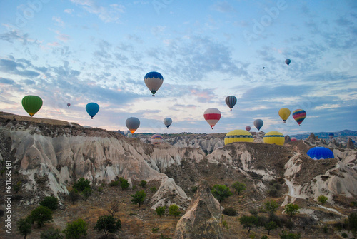 Nevşehir, Cappadocia, Turkey, September,14, 2016 Exotic holiday photo in Turkey landscape with balloons in sunrise, traditional trip ,fairy chimneys landscape background © sumeyye