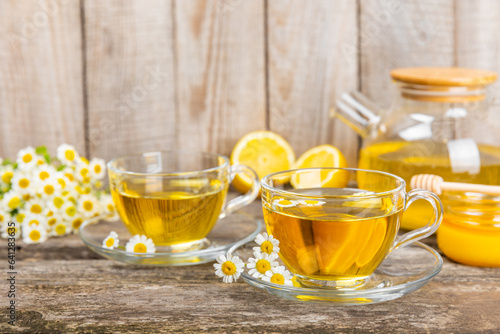 Herbal tea with fresh chamomile flowers on textured background. Calming and relaxing drink. Immunity.Cup of hot chamomile tea. Tea drinking concept. Tea ceremony. Place for text, copy space.