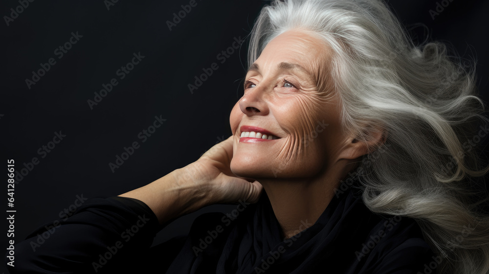 Portrait of a beautiful mature woman. With long white hair, she poses in a natural way.