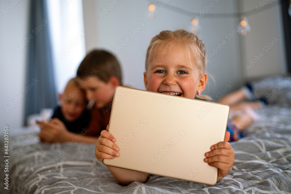 Portrait of happy children using digital devices and having fun together. Portrait of happy children using digital devices and having fun together.