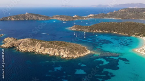 Panoramic drone view of the coastline of a perfectly clear sea on the Italian island of Sardinia. Turquoise sea with white beaches