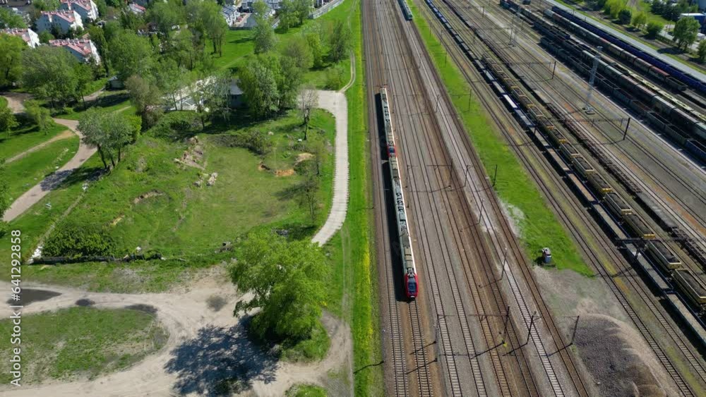 Flying above industrial railroad station with cargo trains and freight ...