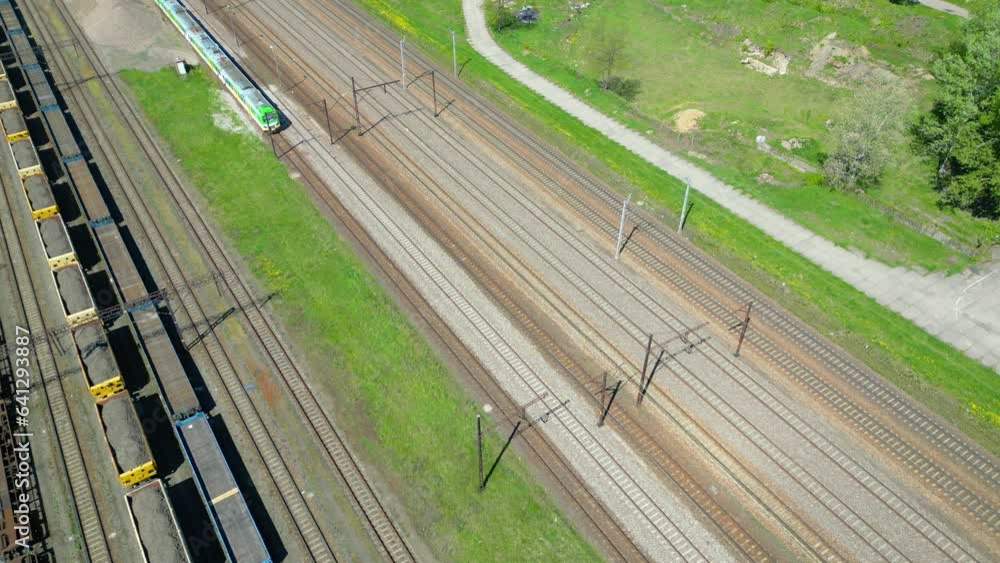 Flying above industrial railroad station with cargo trains and freight ...