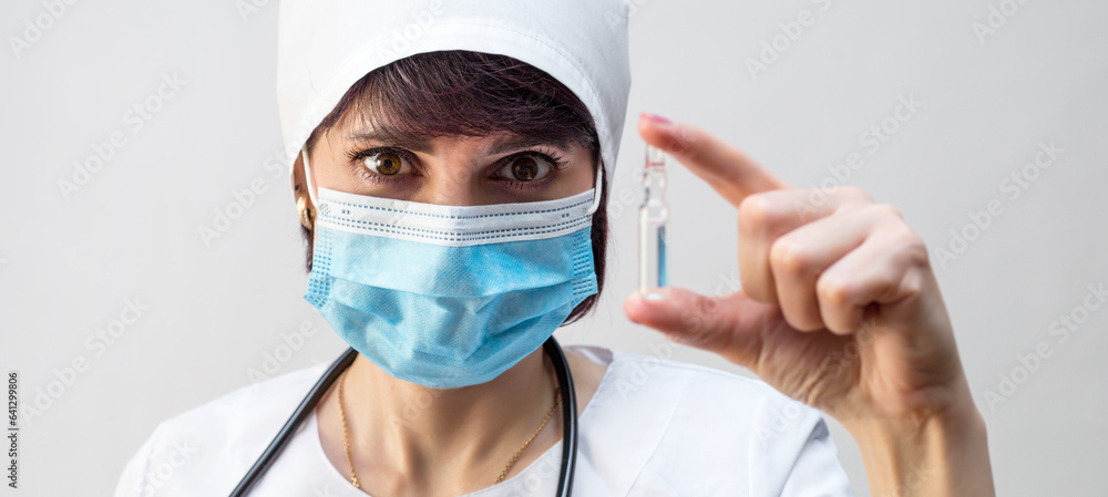 Portrait of a nurse with ampoule of medicine in her hand. Portrait of a nurse with ampoule of medicine in her hand.