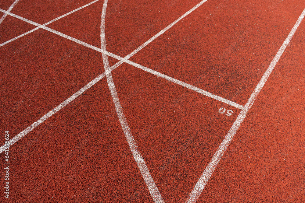 Running track surface with lanes and lines on a track and field athletics stadium. Sport running, jogging or walking runway.