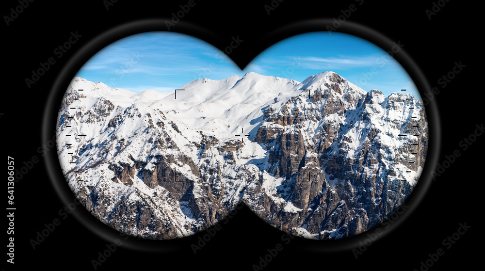 Binoculars point of view with snow capped peaks of Italian Alps