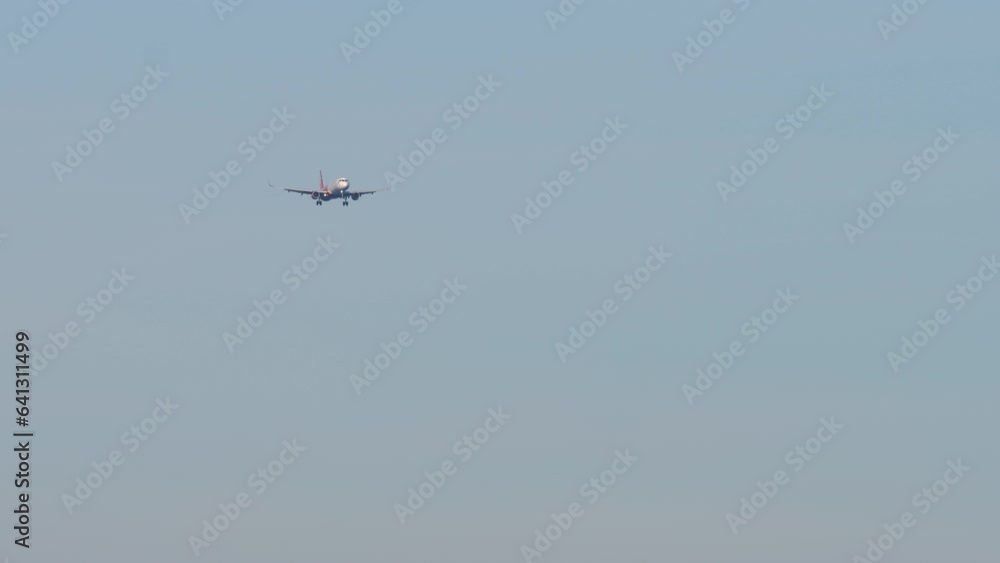 Shot of passenger jet aircraft approaching before landing. Commercial airplane flies. Background of plane in sky. Aviation concept Shot of passenger jet aircraft approaching before landing. Commercial airplane flies. Background of plane in sky. Aviation concept
