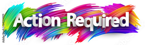 Action required paper word sign with colorful spectrum paint brush strokes over white.