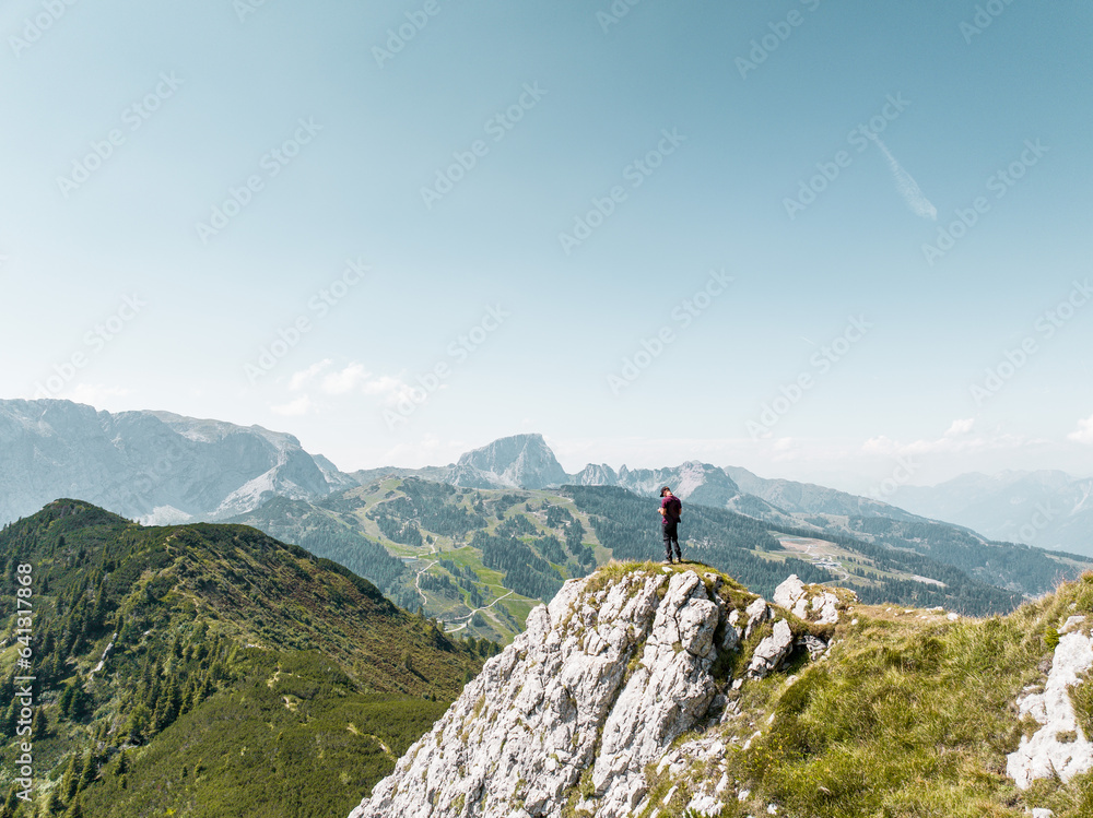 Hiker amazed by the scenery of the Mountains in Nassfeld Austria