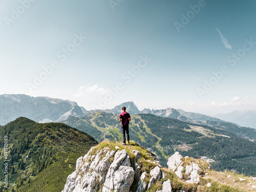 Fototapeta Naklejka Na Ścianę i Meble -  Hiker amazed by the scenery of the Mountains in Nassfeld Austria