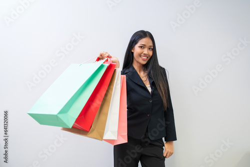 Happy beautiful woman showing shopping bags with goods, buying with discounts. 