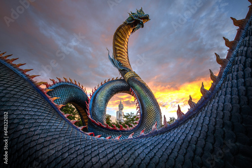 Phaya Si Mukda Maha Muni Nilapala Nakkharat The King of giant Naga statue  at Wat Phu Manorom in sunset,Mukdahan Province Thailand. photo