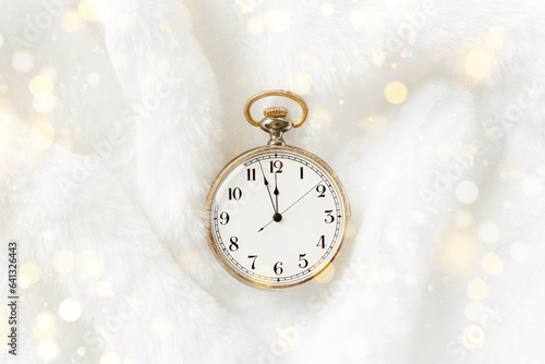 Vintage pocket watch showing 12 oclock night, holiday midnight on clock face, twelve hour, Old watch on white fur background, copy space. New Year, Christmas, xmas concept, sparkle golden bokeh