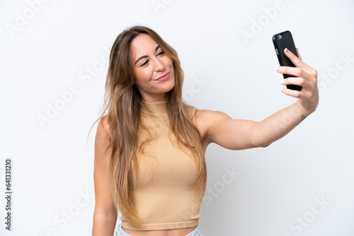 Young caucasian woman isolated on white background making a selfie