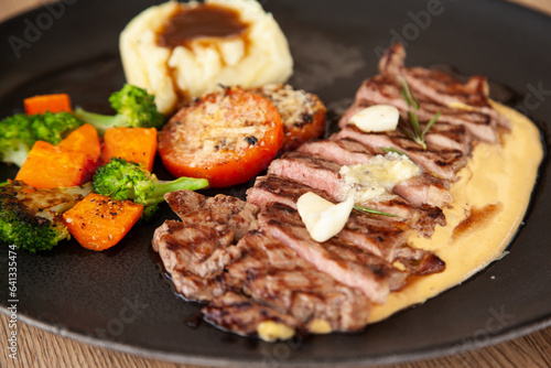 Striploin angus steak with mashed potato and grilled vegetable